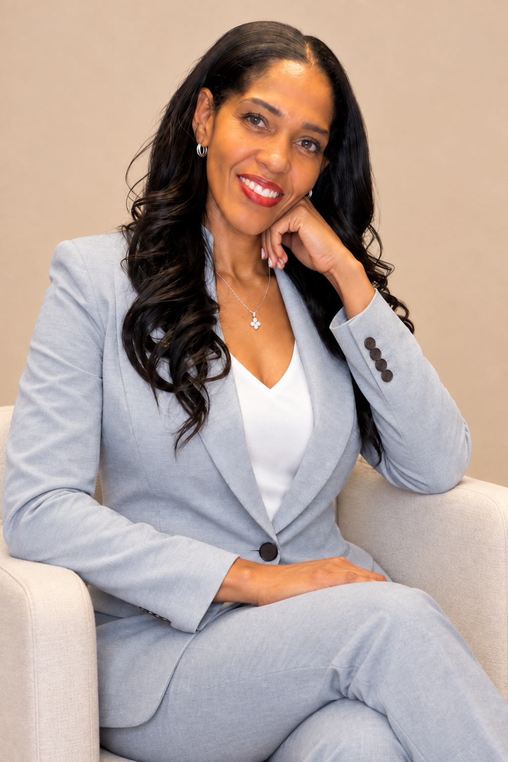 SaKora Perkins seated in a light gray suit
